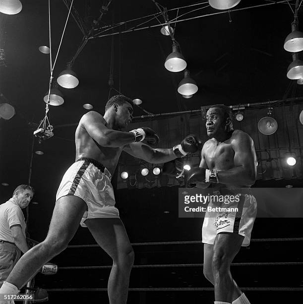 Heavyweight champion Sonny Liston grimaces as Cassius Clay shakes him up with a left in the 6th round of their 1964 title fight. Clay beat Liston on...