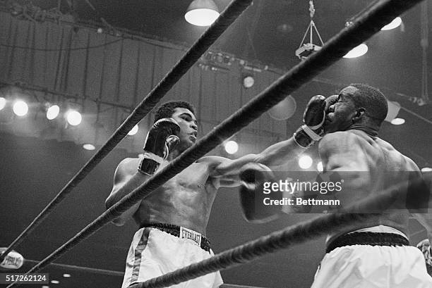 Boxer Cassius Clay punches boxer Sonny Liston in the sixth round during their fight in 1964. Clay, later known as Muhammad Ali, knocked Liston out in...