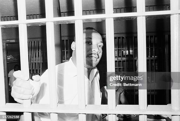 June 12, 1962-St. Augustine, Florida: Dr. Martin Luther King peers between the bars of his jail cell at the St. John's County Jail here on June 11th...