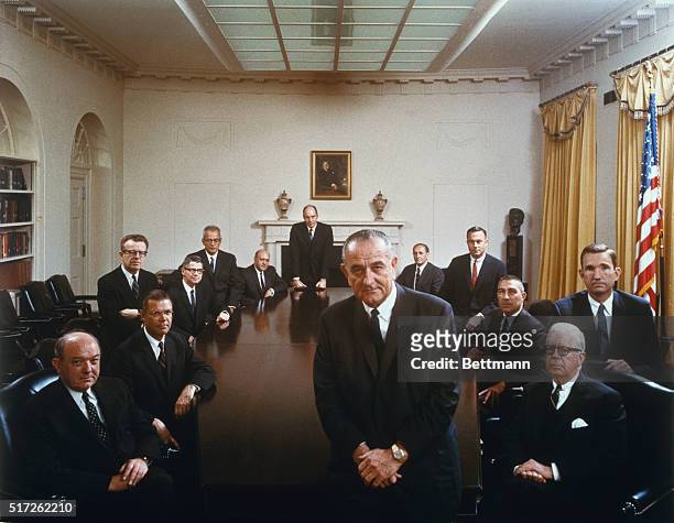 President Johnson poses with his cabinet in this color photo taken by the White House last Wednesday and released April 7. Clockwise around the...