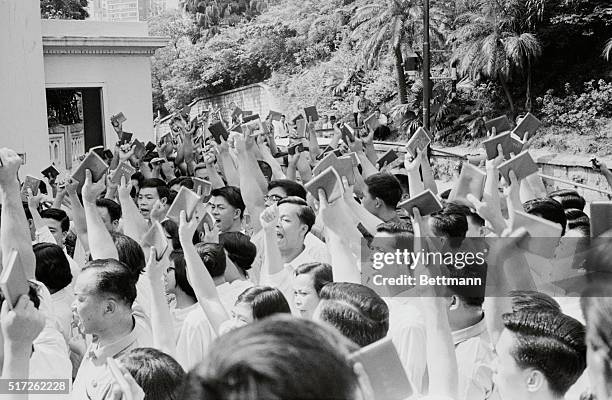 Demonstration: Hong Kong: Chinese demonstrators wave little red books containing quotations by Peking leader Mao Tse-Tung as they chant insults...