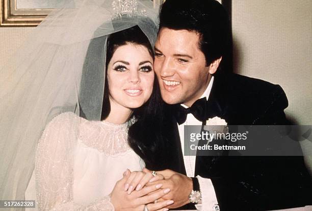 Las Vegas, Nev..Entertainer, Elvis Presley sits cheek to cheek wit his bride, the former Priscilla Ann Beaulieu, following their wedding May 1, 1967.