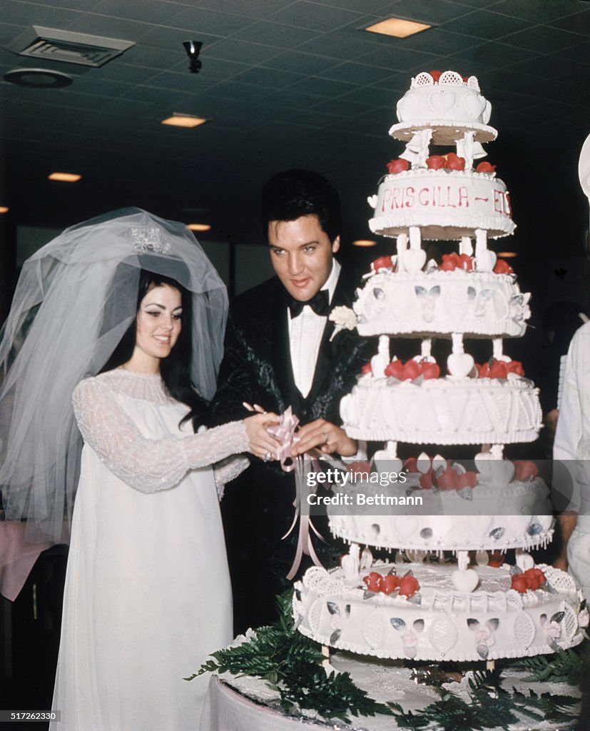 Elvis and Priscilla Presley Cutting Wedding Cake
