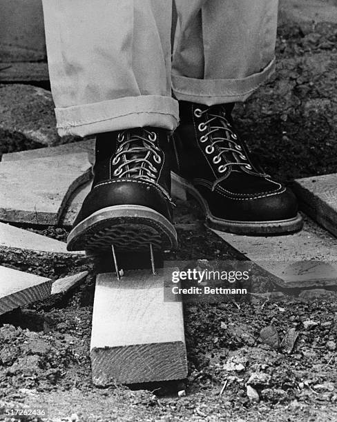 You won't hear an ouch from this carpenter! He's wearing steel-lined work shoes originally designed as combat boots to protect infantrymen in Vietnam...