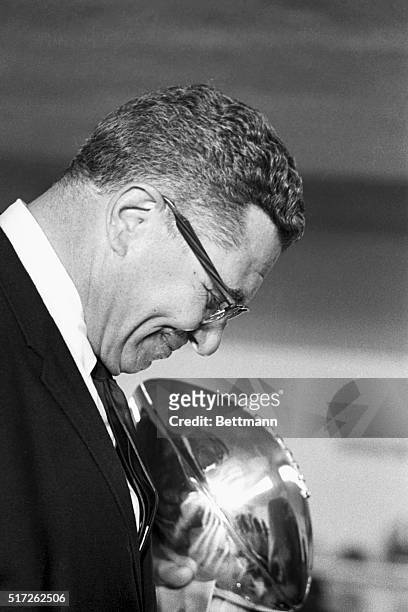 Happy Vince Lombardi bows his head during post-game news conference after his Green Bay Packers smashed the Oakland Raiders, 33-14, to win the second...