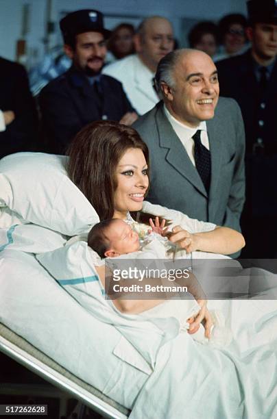 Pleases Parents. Geneva: Sophia Loren has a pat on the cheek for her husband, film producer Carlo Ponti, and a smile for her son, Carlo Ponti Jr., as...