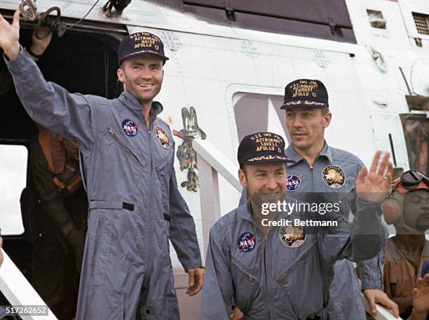 Aboard the Iwo Jima. After splashdown, Apollo 13 astronauts arrive by helicopter on deck of the carrier USS Iwo Jima. Left to right: Fred Haise,...