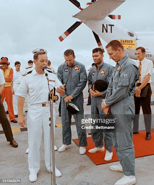 Aboard The Iwo Jima. Apollo 13 astronauts James Lovell, Fred Haise, and John Swigert , bow heads in a prayer offered by Navy Chaplain Lt. Commander...