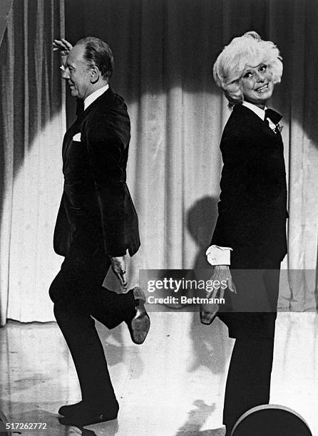 Sir John Gielgud may not feel quite at home kicking up his heels with Carol Channing as he does performing in a Shakespearean play, but he does quite...