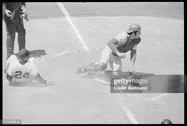 San Francisco Giant's centerfielder Willie Mays is tagged out here at home plate by Cincinnati Reds catcher Johnny Bench in the 3rd inning after...