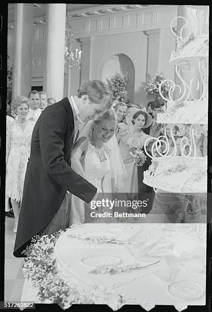 Washington: The newlyweds, Edward Finch Cox and Tricia Nixon, cut their six-tier wedding cake at a reception in the East Room following their wedding...