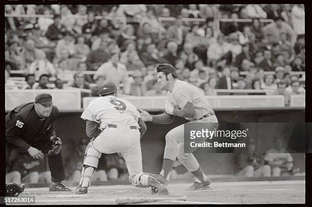 Pete Rose is tagged out at home as he slams into Mike Ryan who has caught Phils' Larry Bowa throw on Johnny Bench's grounder in the first inning of...