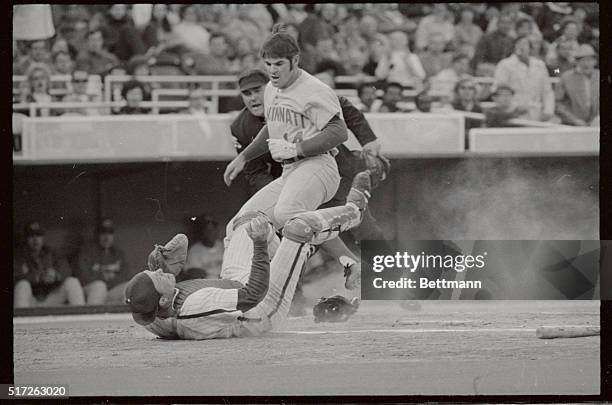 Pete Rose is tagged out at home as he slams into Mike Ryan who has caught Phils' Larry Bowa throw on Johnny Bench's grounder in the first inning of...