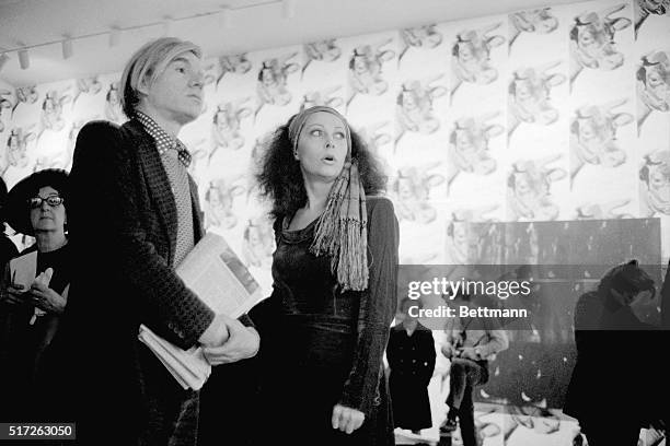 Andy Warhol stands with superstar Ultra Violet at the opening of his exhibit at the Whitney Museum.