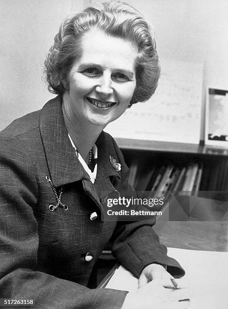 London, England- Mrs. Margaret Thatcher, shown at her desk in her office, is the only female member of Britain's new cabinet. She is Minister of...