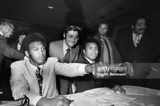 Muhammad Ali , the 29-year-old former heavyweight champion of the world, compares fists with Jimmy Ellis, the 31-year-old former WBA champion, at...