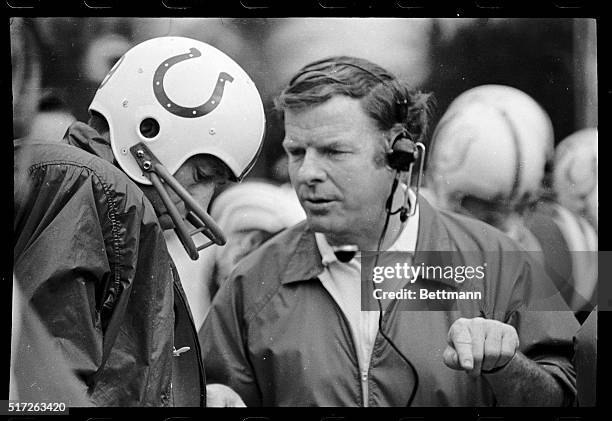 Quarterback Johnny Unitas conferring with coach John Sandusky during Unitas' last game as a Baltimore Colt.