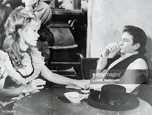 Actress Karen Black, as a bar girl, invites singer Johnny Cash, as ex-gunman Abe Cross, to spend the evening with her in the new Paramount picture A...