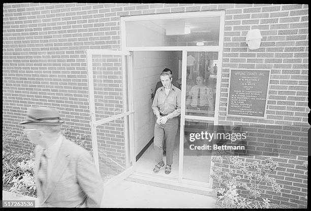 William "Junior" Pierce prepares to enter the applying County Superior Court from the county jail here early 8/16 morning. Escorted by Sheriff's...