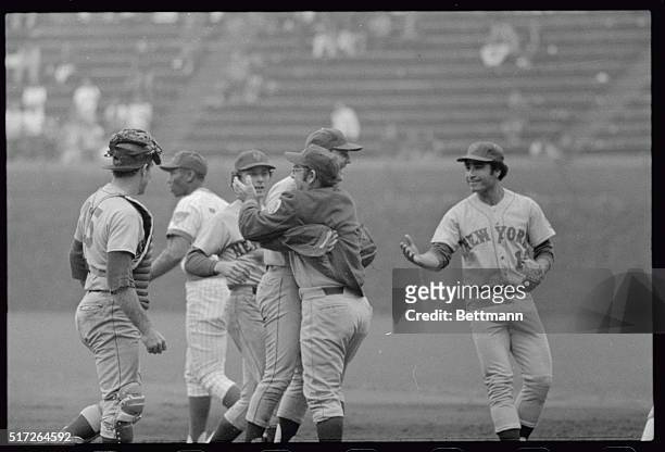 Mets' manager Yogi Berra hugs relief pitcher Tug McGraw on the mound after the Mets beat the Cubs, 6-4, to win the National League East title. At...