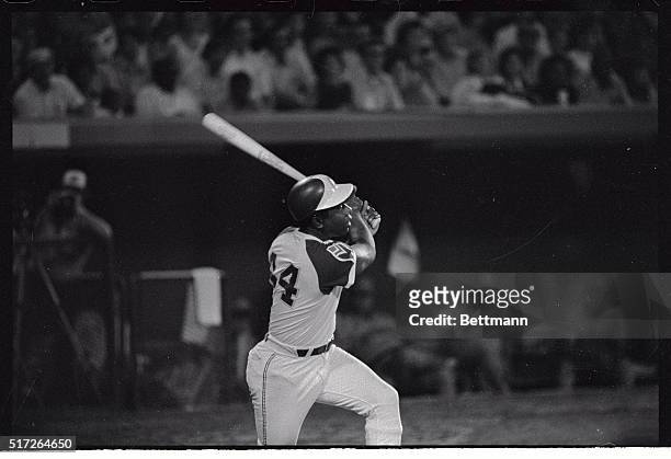 Hank Aaron pauses a moment at the plate to watch his ball sail over the fence in the fifth inning for his 713th home run. Pitching for the Houston...