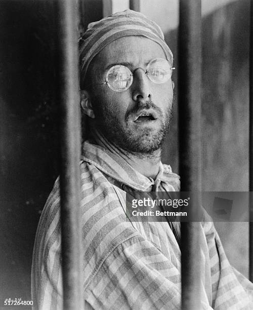 Dustin Hoffman gazes through the iron bars of the prison at French Guiana in the Allied Artists release Papillon, the film version of the sensational...