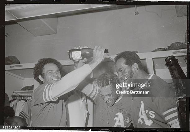 Happy twosome, Bert Campaneris, and Alvin Lewis, have champagne poured on themselves after the Oakland A's won their second consecutive World...