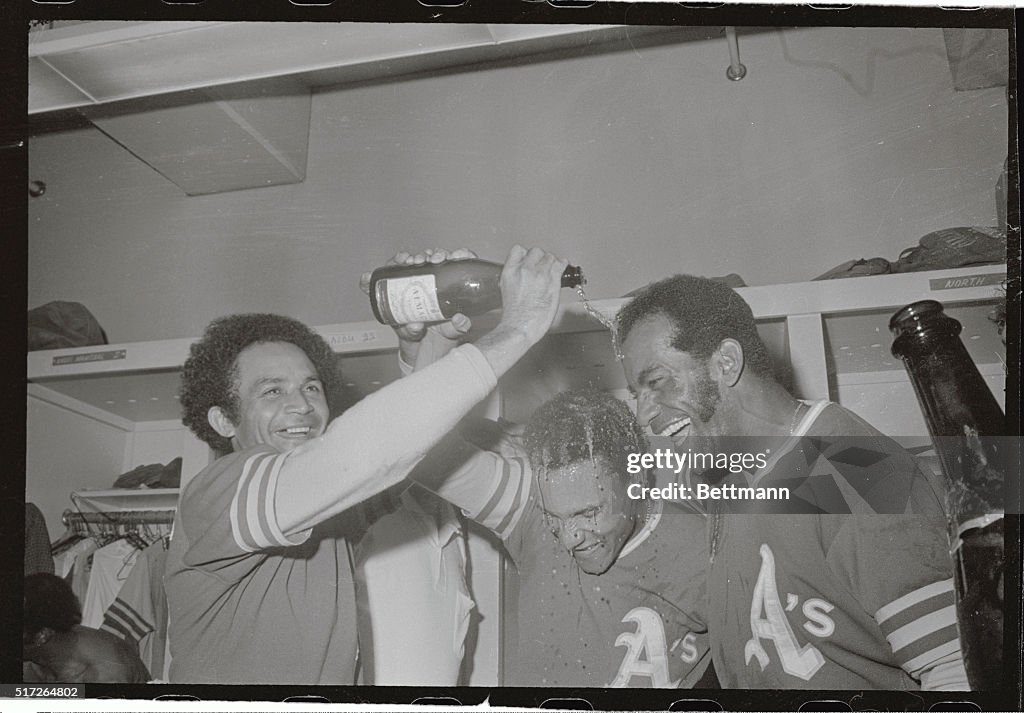 Bert Campaneris and Alvin Lewis Standing Under Champagne Waterfall