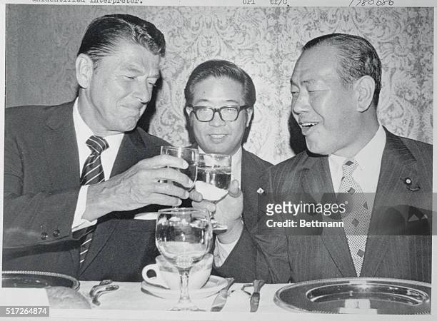 San Francisco, California: Japanese prime minister Kakuei Tanaka makes toast with California Governor Ronald Reagan with water glasses as they await...