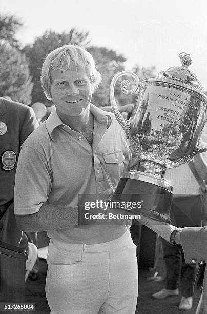 Jack Nicklaus is all smiles as he proudly displays the Professional Golfers Association trophy, emblematic of his 7-under-par 277 victory. Nicklaus...