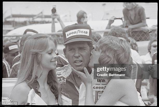 Firecracker 400 winner David Pearson gets a victor's kiss 7/4 after edging Richard Petty at Daytona International Speedway.