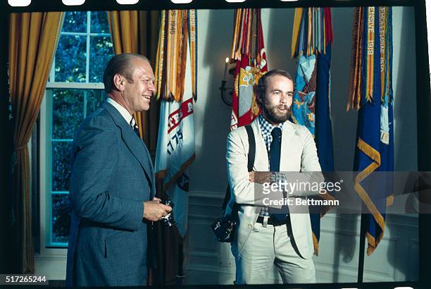 Washington, D.C.: President Gerald Ford introduces his personal photographer, David Hume Kennerly, at the White House August 11th. The president is...
