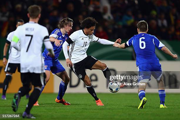 Leroy Sane of Germany is challenged by Jakup Ludvig Thomsen and Jonas Gejel Hansen of Faroe Islands during the 2017 UEFA European U21 Championships...