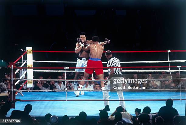 Muhammad Ali throws a hard right to the head of George Foreman in 1st round action in the world heavyweight title bout, Kinshasa, Zaire, . Ali...