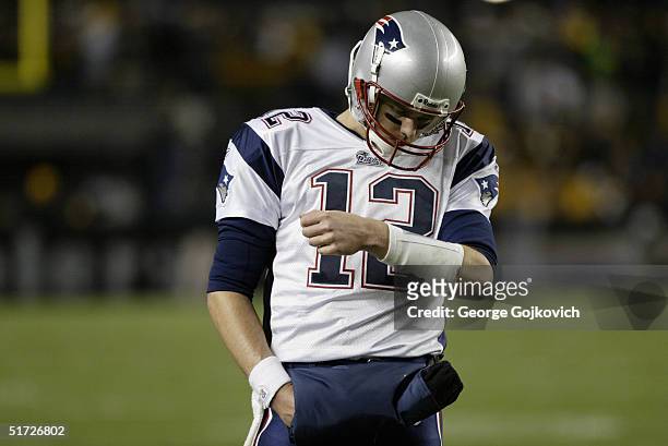 Quarterback Tom Brady of the New England Patriots looks at a play list attached to his wrist during a game against the Pittsburgh Steelers at Heinz...