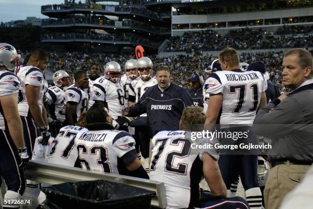 Offensive coordinator Charlie Weis of the New England Patriots talks to members of the offensive unit during a game against the Pittsburgh Steelers...
