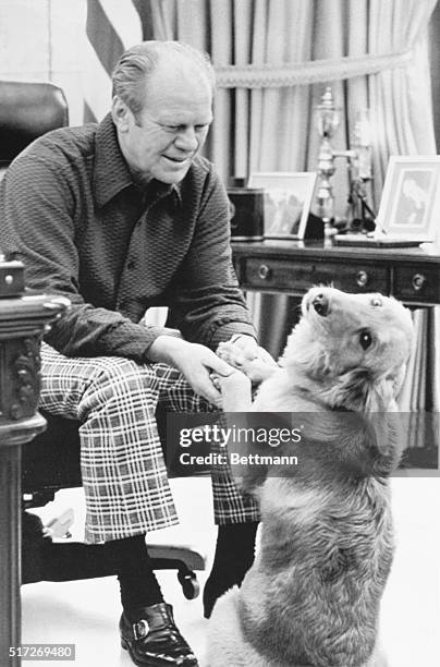 Washington: President Ford enjoys the company of his pet Golden Retriever, Liberty, in the Oval Office. The dog, which was a gift to the Chief...