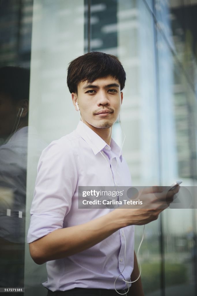 Young man listening to music, portrait