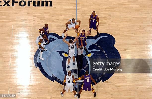 Pau Gasol of the Memphis Grizzlies and Chris Mihm of the Los Angeles Lakers jump for the ball during the tip-off of a game at Fedex Forum on November...