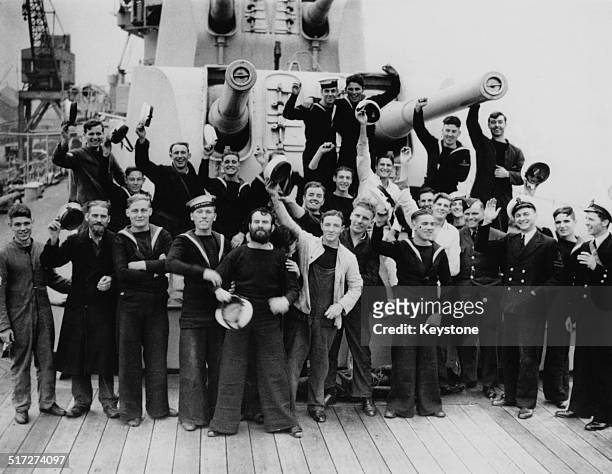 Some of the the crew of the British Royal Navy Leander-class light cruiser, HMS Ajax, in Plymouth on their return from the Battle of the River Plate...