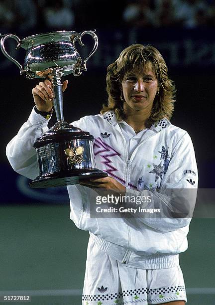 Steffi Graf of Germany raises the trophy after winning the Australian Open at Flinders Park 1988, in Melbourne, Australia.