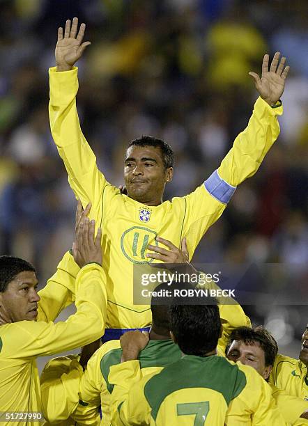 Brazilian striker Romario de Souza Faria is lifted up by his teammates after he scored the first of his two goals during the second half action of...