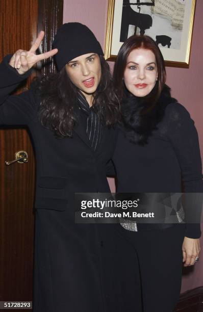 Actresses Demi Moore and Priscilla Presley backstage after seeing 'We Will Rock You', the Queen musical at the Dominion Theatre on November 10, 2004...