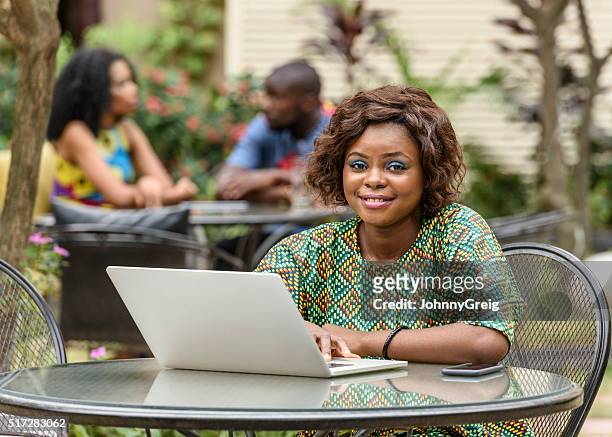 young nigerian woman using laptop computer - 尼日利亞 個照片及圖片檔