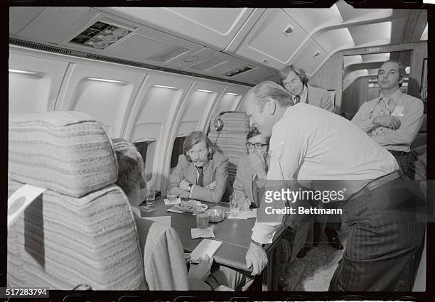 President Gerald Ford holds a mini news conference aboard Air Force One with pool reporters 10/19. Ford was enroute from Louisville, Kentucky to...