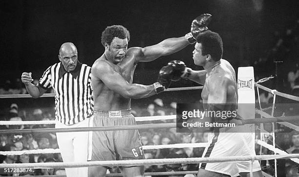 Kinshasa, Zaiere: Heavyweight champ George Foreman , throws a left to the eye of the Muhammed Ali during their title bout, this shot twisted Ali's...