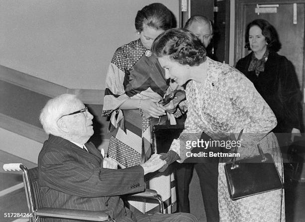 London, England: Queen Elizabeth shaking hands with Sir Charles Chaplin the veteran actor, who will be 87 next month. He made a surprise appearance...