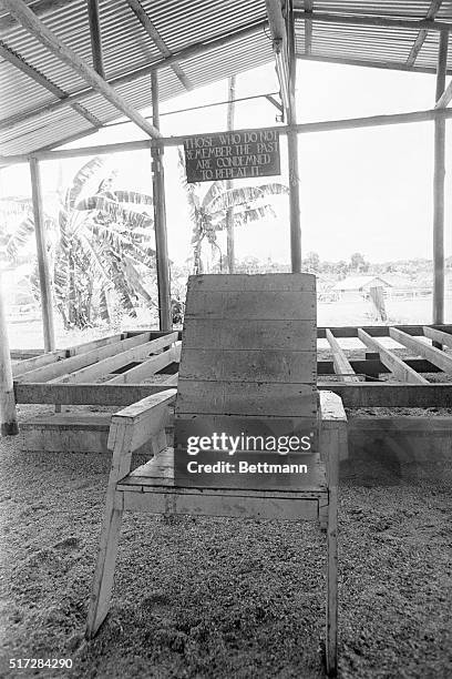 Jim Jone's lawn chair "throne" stands in front of the stage in the main pavilion, its floor boards torn up because "they were soaked with blood," in...