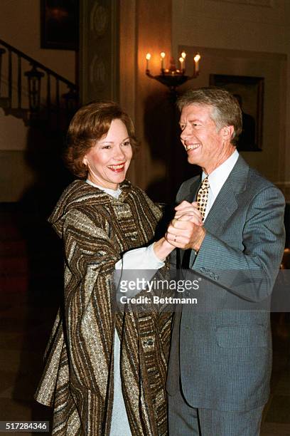 President and Mrs. Carter break into an impromptu waltz on the State Floor while awaiting the arrival of Vice Premier Deng Xiaoping and party to sign...
