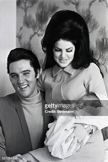 Memphis, Tenn: A very happy Elvis Presley prepares to join his wife, Priscilla Beaulieu Presley, and four-day-old daughter, Lisa Marie, as they leave...